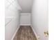 Spacious walk-in closet with wire shelving and wood-look vinyl flooring for storage and organization at 3300 Pierce St, College Park, GA 30337