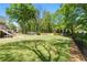 This backyard boasts a sprawling lawn, mature trees, and storage shed, offering endless possibilities at 4340 Hadaway Nw Rd, Kennesaw, GA 30152