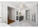 Elegant bathroom featuring marble floors, a chandelier, and a gray vanity at 4340 Hadaway Nw Rd, Kennesaw, GA 30152