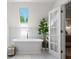 Bright bathroom featuring a freestanding tub beneath a skylight, enhancing relaxation and natural light at 4340 Hadaway Nw Rd, Kennesaw, GA 30152