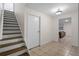Inviting entryway with wood stairs, neutral walls, and tiled flooring leading to a bright living space at 4340 Hadaway Nw Rd, Kennesaw, GA 30152