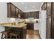 Kitchen featuring dark cabinetry, granite countertops, and a breakfast bar perfect for casual dining at 4340 Hadaway Nw Rd, Kennesaw, GA 30152