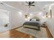 Tranquil primary bedroom with hardwood floors, a tray ceiling, and ensuite bath access at 4340 Hadaway Nw Rd, Kennesaw, GA 30152