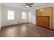 Spacious bedroom featuring hardwood floors, two windows, ceiling fan and a wooden Murphy bed at 1355 E Rock Springs Ne Rd, Atlanta, GA 30306