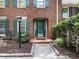 A brick home with a green door, green shutters, and a well-manicured front yard at 1355 E Rock Springs Ne Rd, Atlanta, GA 30306