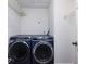 This is a laundry room with two large blue front-load washers and dryers, white walls and wire shelving at 1355 E Rock Springs Ne Rd, Atlanta, GA 30306