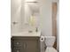 Bathroom featuring a vanity with sink, mirror, toilet, and shower tub combination with tiled walls at 136 Peachtree Memorial Nw Dr # 8-2, Atlanta, GA 30309