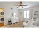 Comfortable Bedroom with crib, decor, ceiling fan and laundry room off to the side at 136 Peachtree Memorial Nw Dr # 8-2, Atlanta, GA 30309