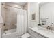 Bright bathroom with bathtub and shower with shower curtain and marble countertops at 1995 Bryant Park Ln, Decatur, GA 30033