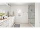 Bright bathroom featuring a double vanity with white cabinets and a glass-enclosed shower with a built-in bench at 1995 Bryant Park Ln, Decatur, GA 30033