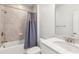 Well-lit bathroom featuring a shower and bathtub, vanity, and quartz countertop at 1995 Bryant Park Ln, Decatur, GA 30033