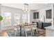Elegant dining area with modern lighting, a built-in wine cooler, and bright natural light at 1995 Bryant Park Ln, Decatur, GA 30033