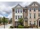 Charming brick townhome with a sunny yellow front door, inviting curb appeal, and flowering plants at 1995 Bryant Park Ln, Decatur, GA 30033