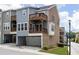 Exterior of home featuring a garage, multiple stories, and small yard at 1995 Bryant Park Ln, Decatur, GA 30033