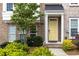 Close up of brick townhome entrance with yellow door, green landscaping, and charming details at 1995 Bryant Park Ln, Decatur, GA 30033