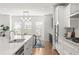 Open kitchen with stainless appliances, white cabinets, island with sink and breakfast bar and eat in dining area at 1995 Bryant Park Ln, Decatur, GA 30033