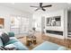 Bright and airy living room with fireplace, hardwood floors, stylish furniture, and large windows at 1995 Bryant Park Ln, Decatur, GA 30033