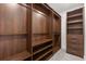 Spacious walk-in closet boasts custom wood shelving, drawers, and ample storage space at 1995 Bryant Park Ln, Decatur, GA 30033