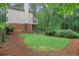 Expansive backyard with a covered patio, mature trees, and a brick chimney at 2206 Heritage Trace Dr, Marietta, GA 30062