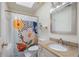 Well-lit bathroom featuring a colorful shower curtain, modern sink, and tile floor at 2206 Heritage Trace Dr, Marietta, GA 30062
