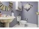 Stylish powder room featuring a unique sink, decorative mirror, and charming decor at 2206 Heritage Trace Dr, Marietta, GA 30062
