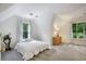 Bright bedroom featuring soft gray carpeting and two windows offering a scenic view at 2206 Heritage Trace Dr, Marietta, GA 30062