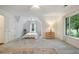Spacious bedroom showcasing a comfortable carpet, a ceiling fan, and large windows overlooking nature at 2206 Heritage Trace Dr, Marietta, GA 30062