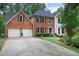 Brick home with a two car garage and manicured lawn at 2206 Heritage Trace Dr, Marietta, GA 30062