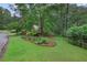 Inviting front yard with well-manicured landscaping, mature trees, and a charming sign at 2206 Heritage Trace Dr, Marietta, GA 30062