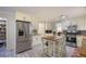 Renovated kitchen with stainless steel refrigerator, center island and a walk-in pantry at 2206 Heritage Trace Dr, Marietta, GA 30062