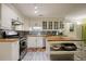 Well-lit kitchen featuring butcher block counters, stainless steel appliances, mosaic backsplash, and light cabinets at 2206 Heritage Trace Dr, Marietta, GA 30062