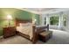 Spacious main bedroom with a green accent wall, large windows, and tray ceiling at 2206 Heritage Trace Dr, Marietta, GA 30062