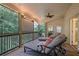 Screened porch with outdoor seating, overhead fan and adjacent view to backyard forest at 2206 Heritage Trace Dr, Marietta, GA 30062