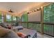 Enjoy outdoor living on this screened porch featuring lounge chairs, an overhead fan and room for entertaining at 2206 Heritage Trace Dr, Marietta, GA 30062