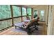 Relaxing screened porch featuring a wood deck, overhead fan and comfortable chaise lounges at 2206 Heritage Trace Dr, Marietta, GA 30062