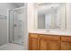 Bathroom featuring a glass shower door, a white vanity, and a large mirror at 2731 Pierce Brennen Ct, Lawrenceville, GA 30043