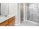 Bathroom with a single sink vanity and a glass-enclosed shower providing a clean and modern design at 2731 Pierce Brennen Ct, Lawrenceville, GA 30043