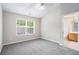 Spacious bedroom featuring neutral paint, gray carpet, ceiling fan, and an en-suite bath at 2731 Pierce Brennen Ct, Lawrenceville, GA 30043