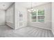 Bright dining room featuring neutral decor, large windows, modern chandelier and plush gray carpeting at 2731 Pierce Brennen Ct, Lawrenceville, GA 30043