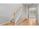 View of the entryway showcasing hardwood floors, staircase, and a glimpse into the living room at 2731 Pierce Brennen Ct, Lawrenceville, GA 30043