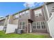 Exterior shot of the back of a multi-story home, showing a yard, patio, and siding at 2731 Pierce Brennen Ct, Lawrenceville, GA 30043
