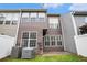 Exterior shot of the back of a multi-story home, showing a yard, patio, and siding at 2731 Pierce Brennen Ct, Lawrenceville, GA 30043