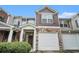 Charming townhome with stone accents, a covered entrance, and an attached one car garage at 2731 Pierce Brennen Ct, Lawrenceville, GA 30043