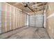 Unfinished garage interior showcasing the door, overhead storage, and bare walls at 2731 Pierce Brennen Ct, Lawrenceville, GA 30043