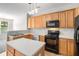 Well-equipped kitchen featuring wooden cabinets, modern appliances, and a functional island at 2731 Pierce Brennen Ct, Lawrenceville, GA 30043