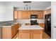 Well-equipped kitchen featuring wood cabinets, modern stainless appliances, and a functional island at 2731 Pierce Brennen Ct, Lawrenceville, GA 30043