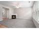 Bright living room features a fireplace, plush carpeting, and lots of natural light through the window at 2731 Pierce Brennen Ct, Lawrenceville, GA 30043