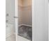 Carpeted walk-in closet with wire shelving next to a soaking tub at 2731 Pierce Brennen Ct, Lawrenceville, GA 30043