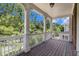Spacious back porch with white columns, railing overlooking lush greenery at 671 Brennan Dr, Decatur, GA 30033