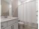 Clean bathroom featuring white tiled shower with curtain and vanity at 671 Brennan Dr, Decatur, GA 30033